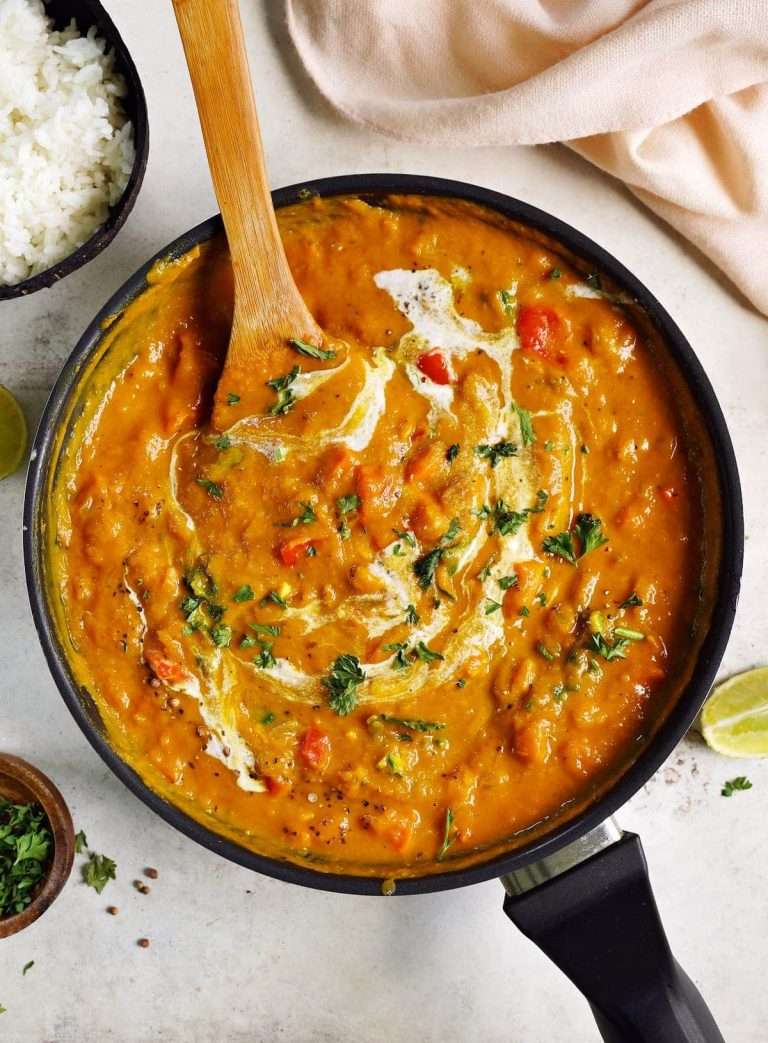 one-pot-pumpkin-curry-in-black-skillet-with-wooden-spoon